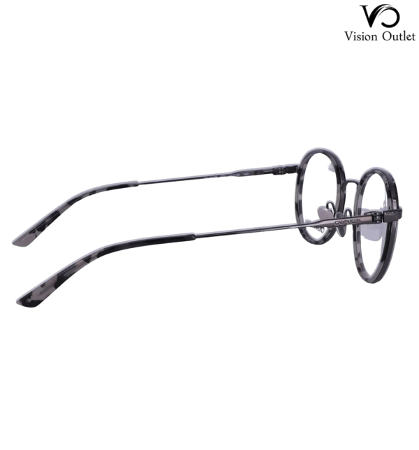 Calvin Klein CK18107 071 round eyeglasses in smoke tortoise, featuring a metal and plastic frame with a 47 mm lens width and included case.